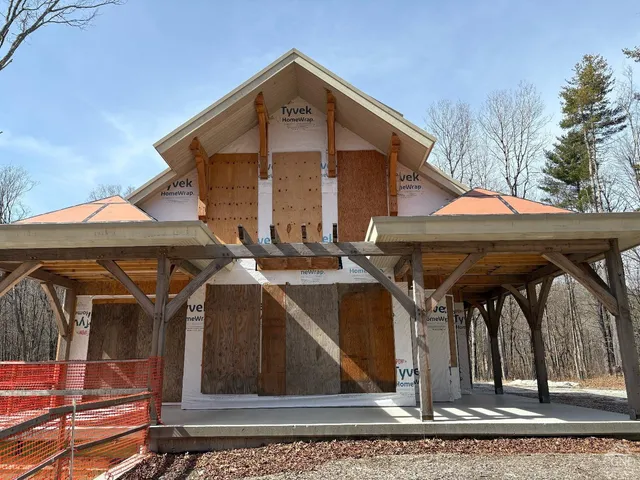 a front view of house with car parked