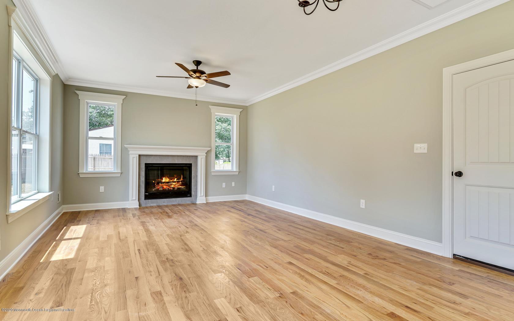 615 Ivanhoe Road Brick, NJ 08723 - Photo 13 of 28 wooden floor fireplace and windows in an empty room