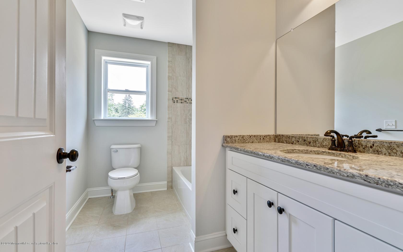 615 Ivanhoe Road Brick, NJ 08723 - Photo 20 of 28 a bathroom with a granite countertop sink and a toilet