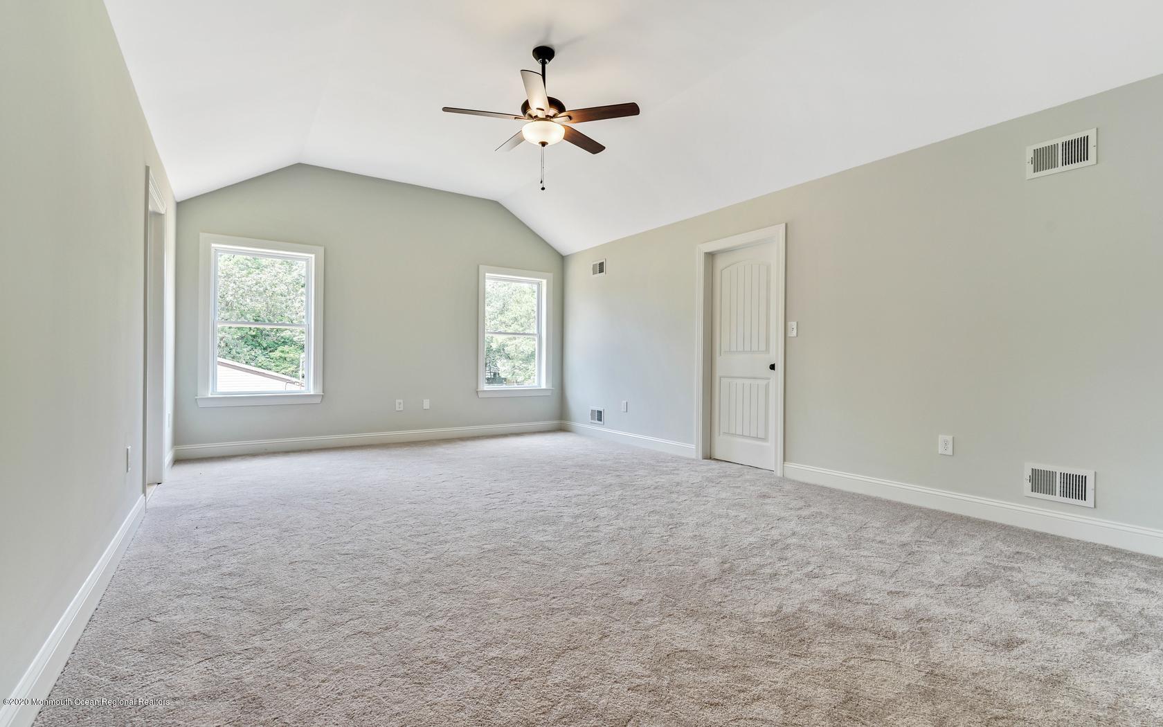615 Ivanhoe Road Brick, NJ 08723 - Photo 23 of 28 an empty room with windows and ceiling fan