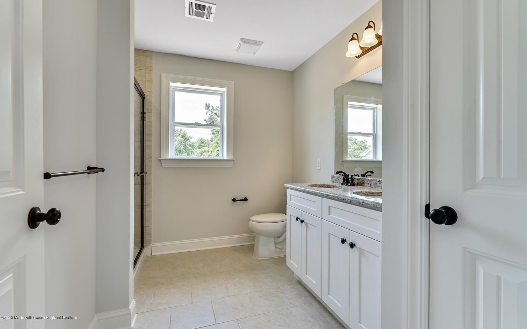 615 Ivanhoe Road Brick, NJ 08723 - Photo 25 of 28 a bathroom with a toilet sink and mirror