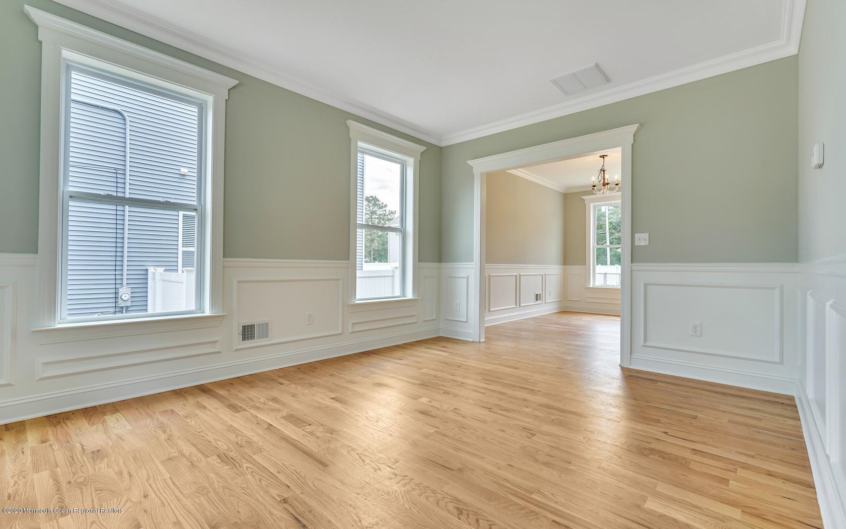 615 Ivanhoe Road Brick, NJ 08723 - Photo 4 of 28 a view of an empty room with wooden floor and a window