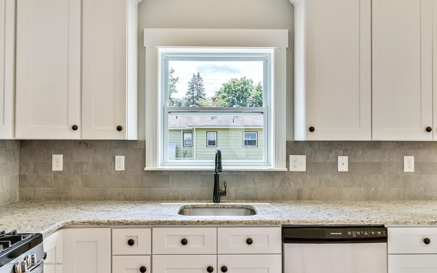 615 Ivanhoe Road Brick, NJ 08723 - Photo 9 of 28 a kitchen with granite countertop white cabinets and a window