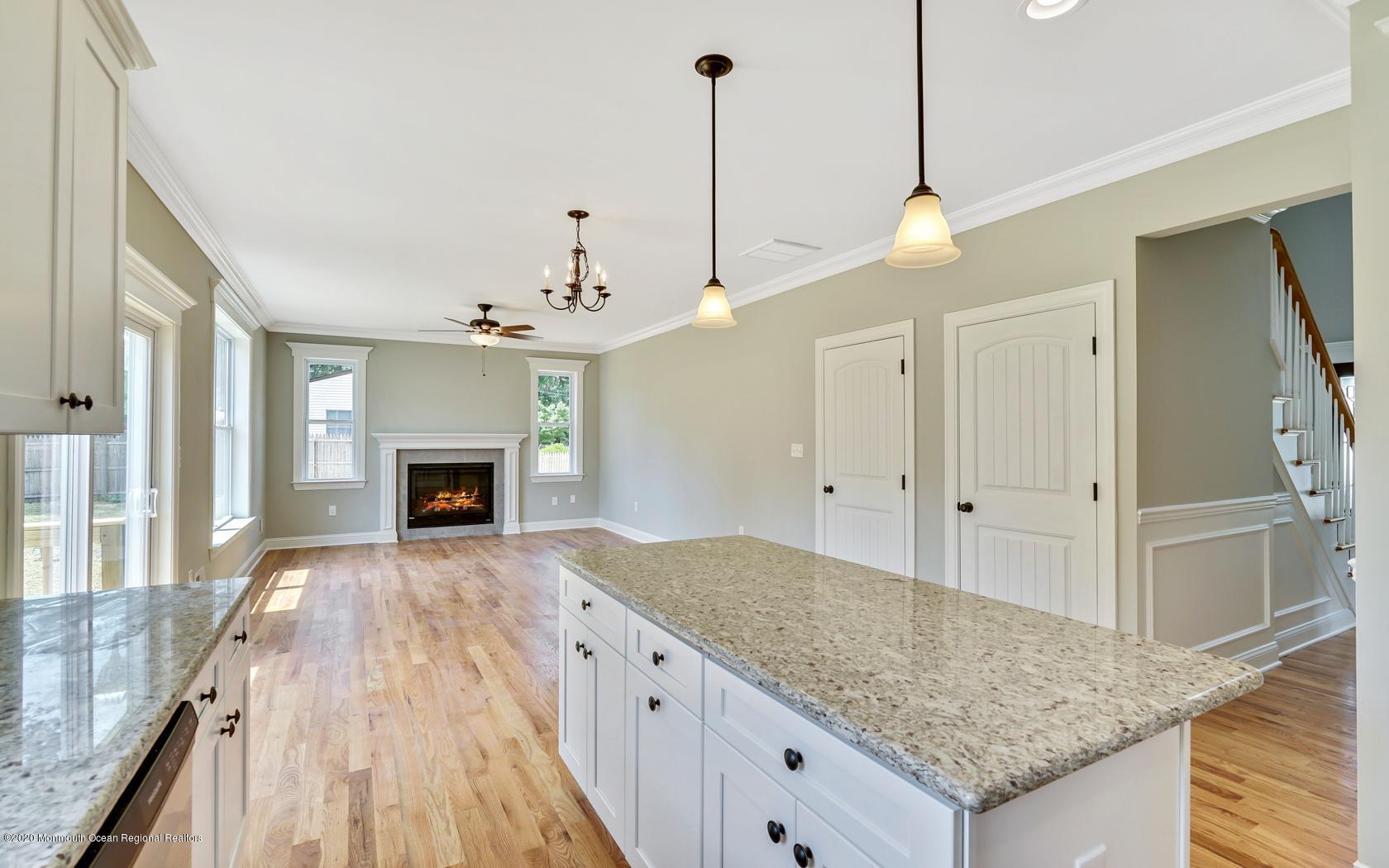 615 Ivanhoe Road Brick, NJ 08723 - Photo 10 of 28 a kitchen with kitchen island granite countertop stove top oven and chandelier