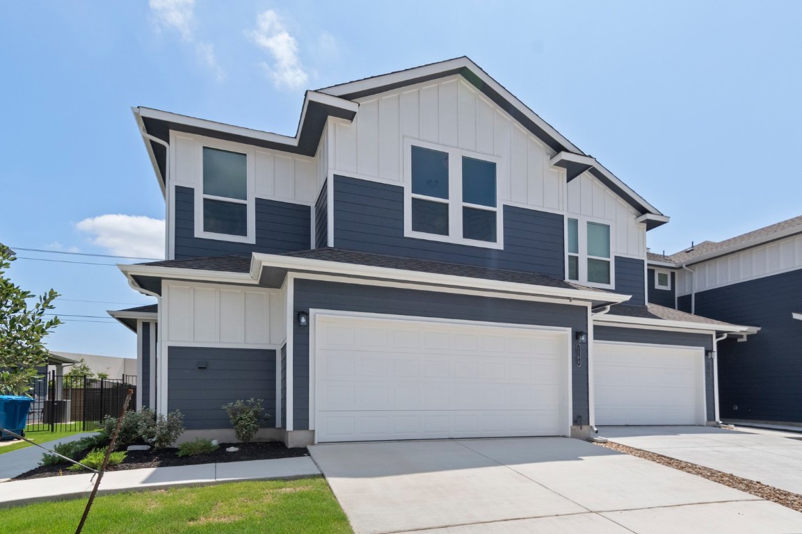 18909 Schultz Lane, Unit 1104 Round Rock, TX 78664 - Photo 1 of 1 Modern farmhouse featuring board and batten siding, a garage, roof with shingles, and driveway