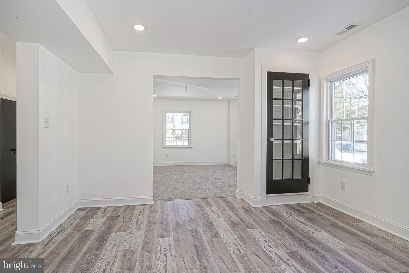 155 Cedar Avenue Pitman, NJ 08071 - Photo 11 of 41 an empty room with wooden floor and windows