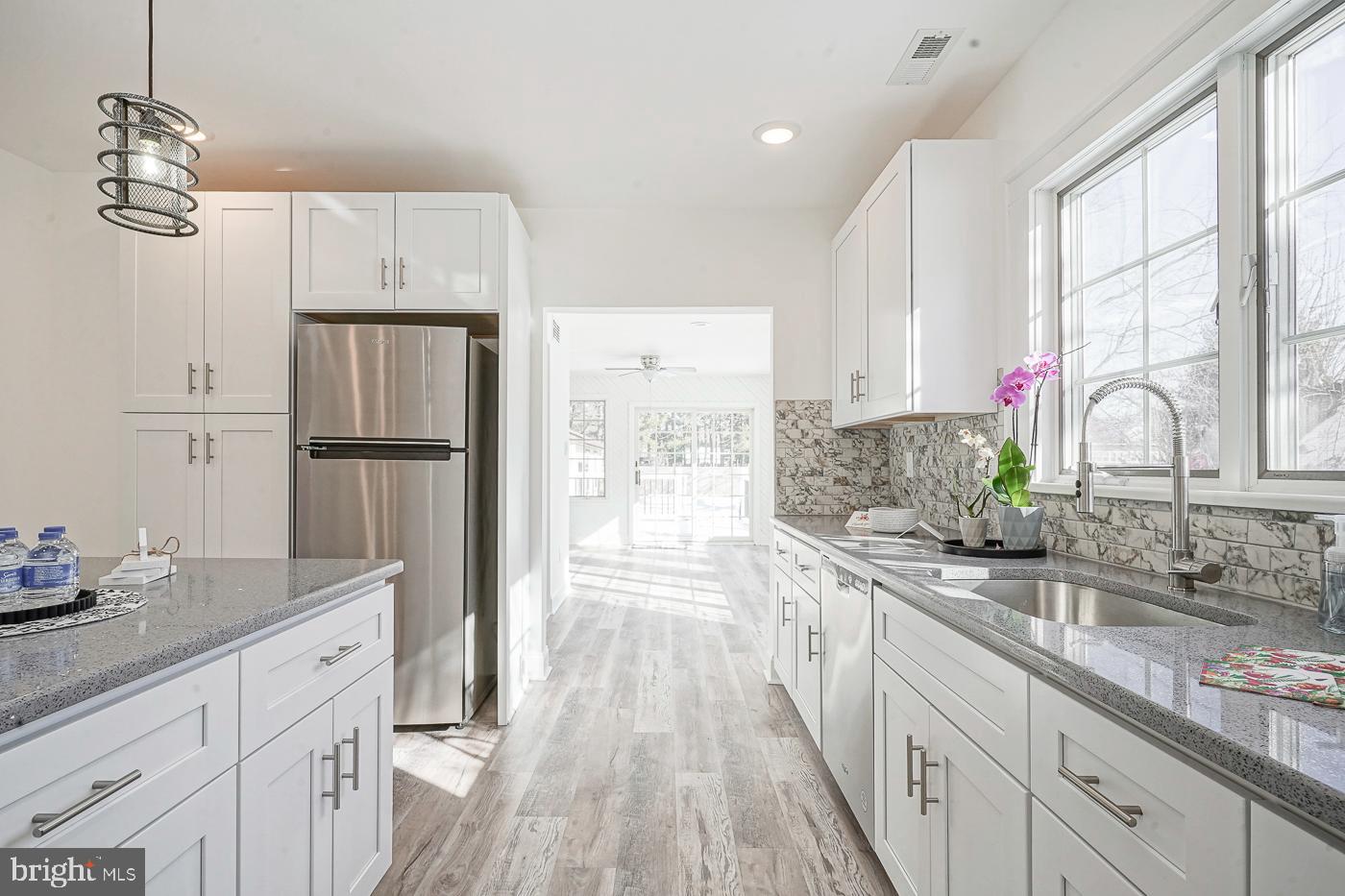 155 Cedar Avenue Pitman, NJ 08071 - Photo 16 of 41 a kitchen with granite countertop a refrigerator and a sink