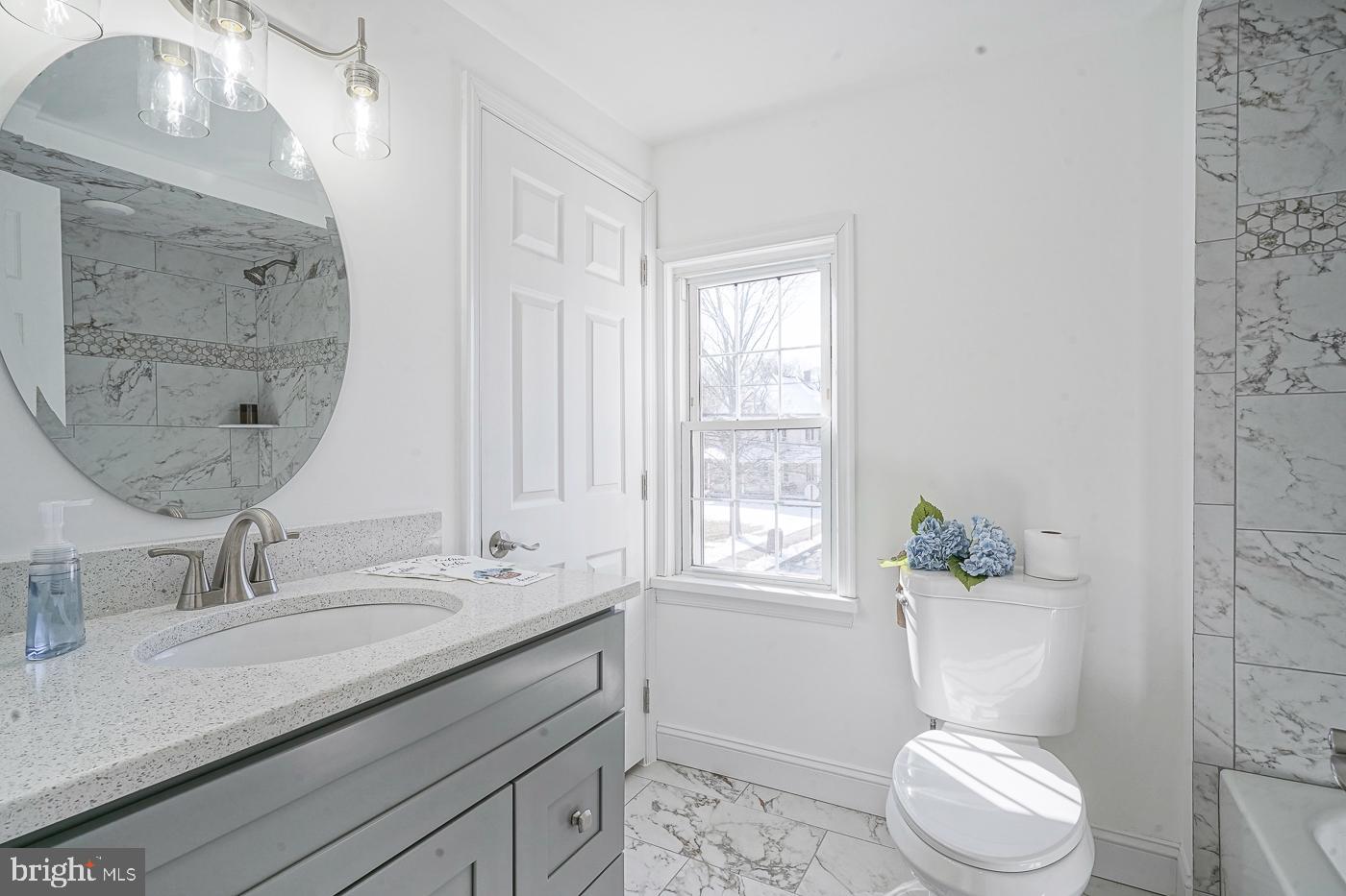 155 Cedar Avenue Pitman, NJ 08071 - Photo 26 of 41 a bathroom with a granite countertop toilet a sink and a mirror