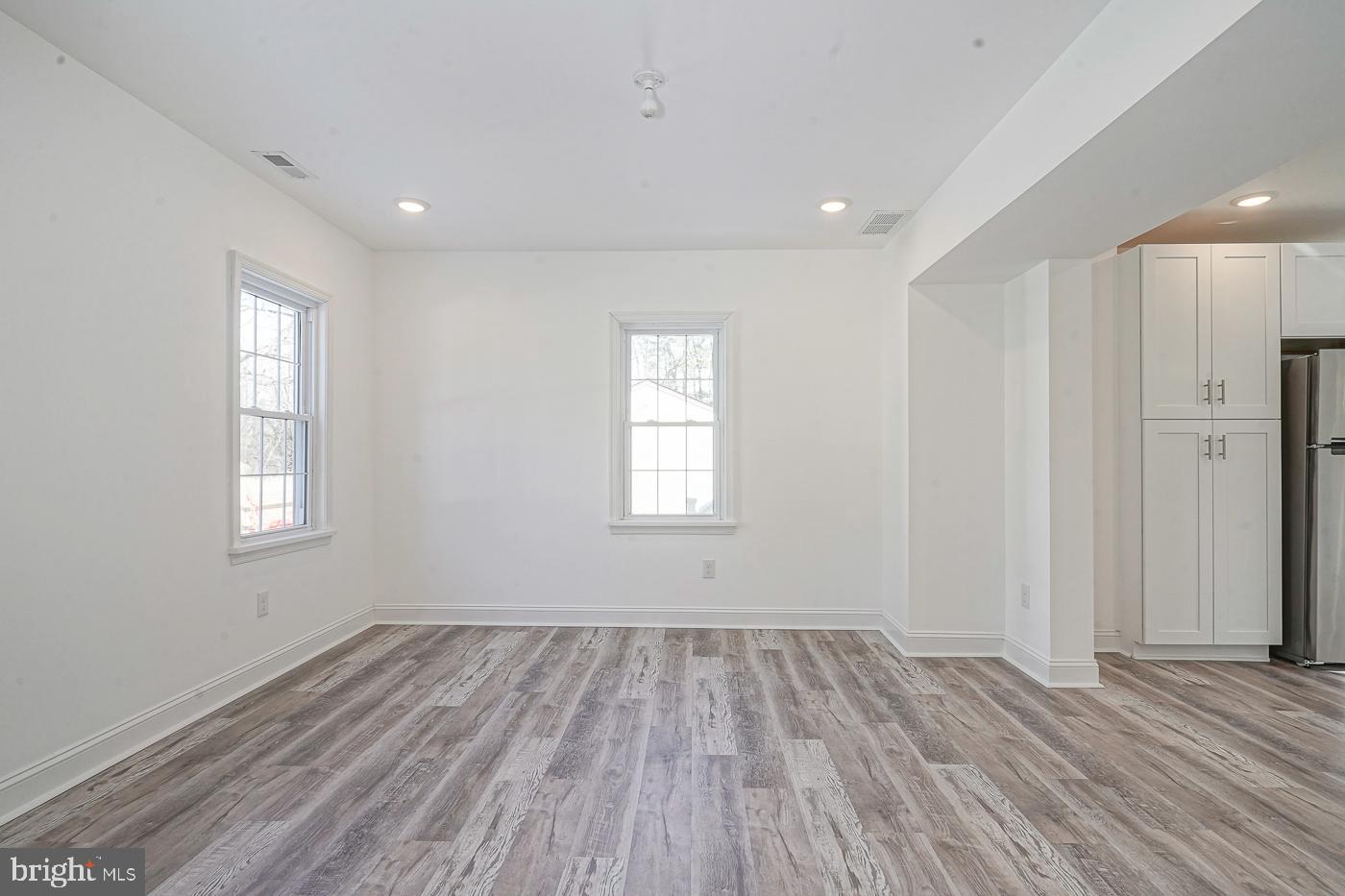 155 Cedar Avenue Pitman, NJ 08071 - Photo 10 of 41 an empty room with wooden floor and windows