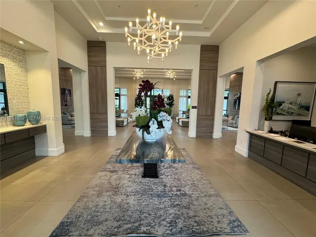 a lobby with furniture and a chandelier