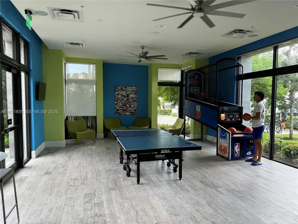 a living room with furniture a piano and a flat screen tv