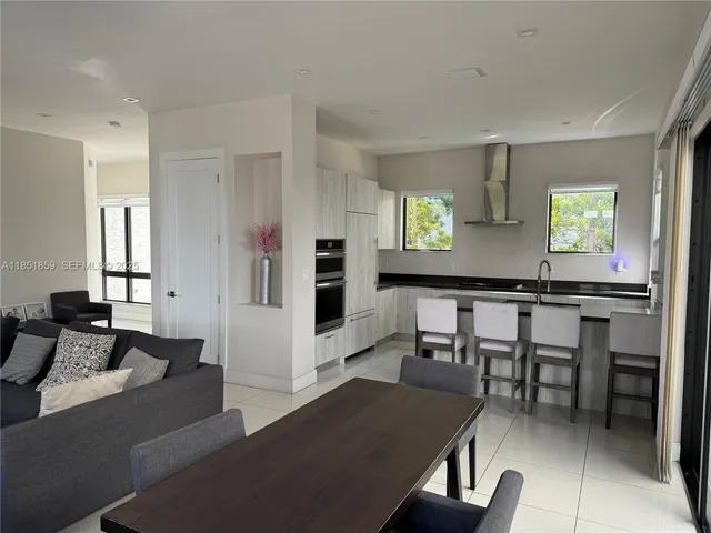 a living room with furniture wooden floor and a window