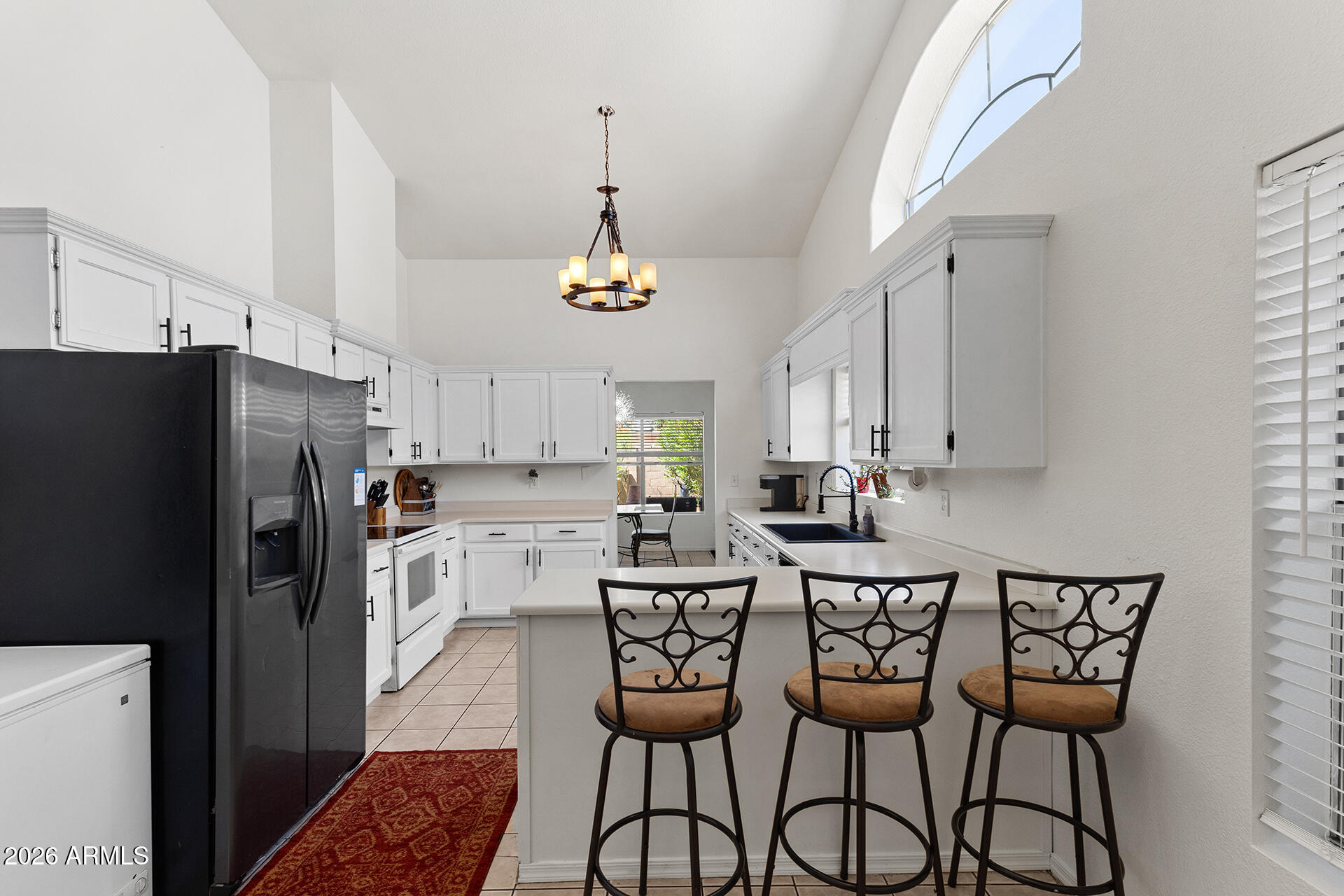 9002 West Coronado Road Phoenix, AZ 85037 - Photo 3 of 54 a kitchen with stainless steel appliances a dining table chairs and refrigerator