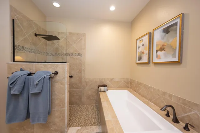 a bathroom with a tub and shower