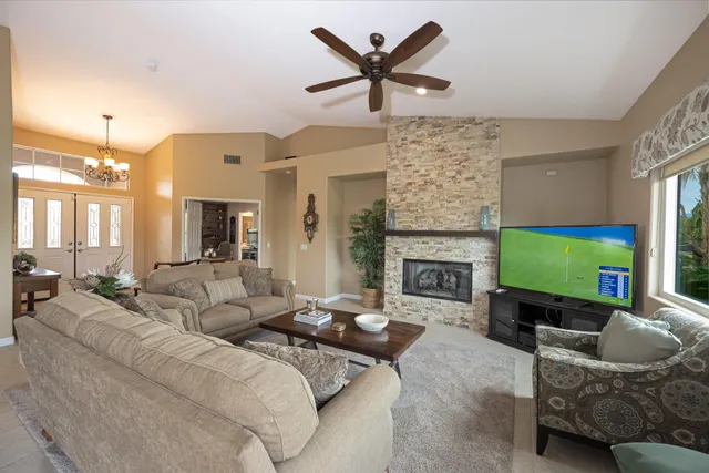 a living room with furniture a fireplace and a flat screen tv