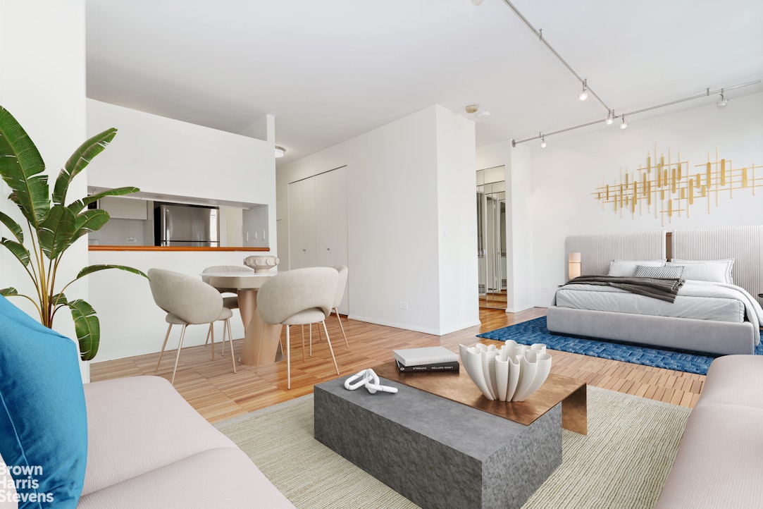 300 East 85th Street, Unit 505 Manhattan, NY 10028 - Photo 2 of 12 a living room with furniture and a potted plant