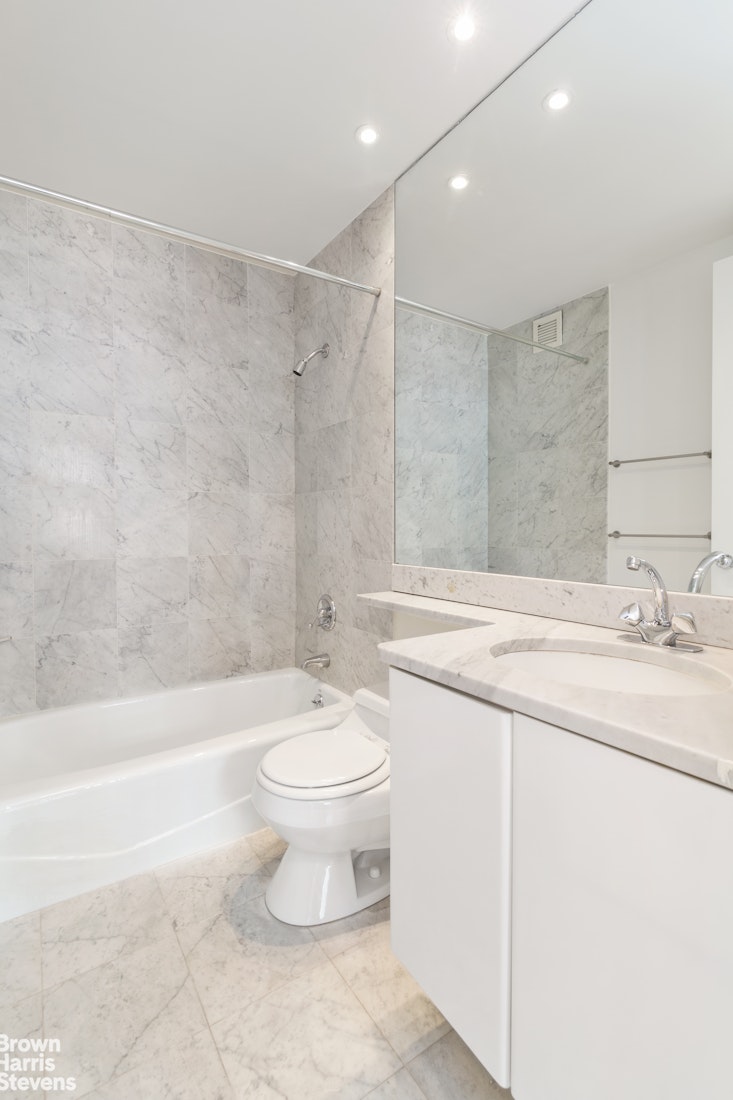 300 East 85th Street, Unit 505 Manhattan, NY 10028 - Photo 5 of 12 a bathroom with a sink a toilet and a bathtub