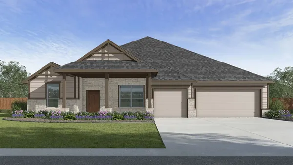 a front view of a house with a garden and yard