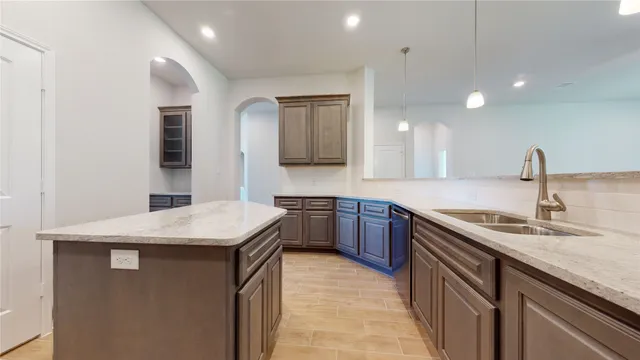 a kitchen with a sink dishwasher a stove and a refrigerator with wooden floor