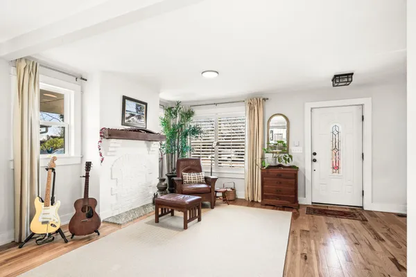 a living room with furniture and wooden floor