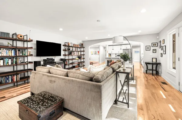 a living room with furniture a flat screen tv and a rug