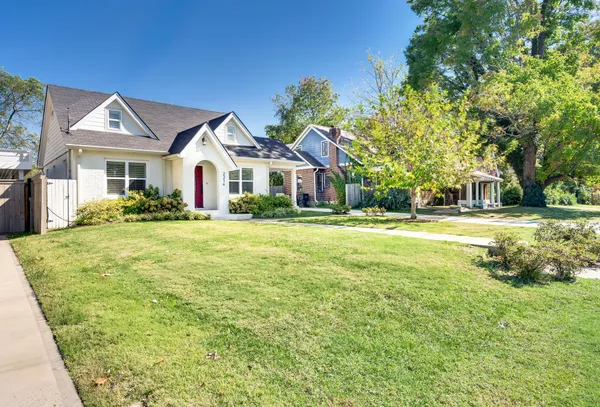 a front view of a house with a garden