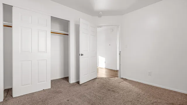 an empty room with closet area