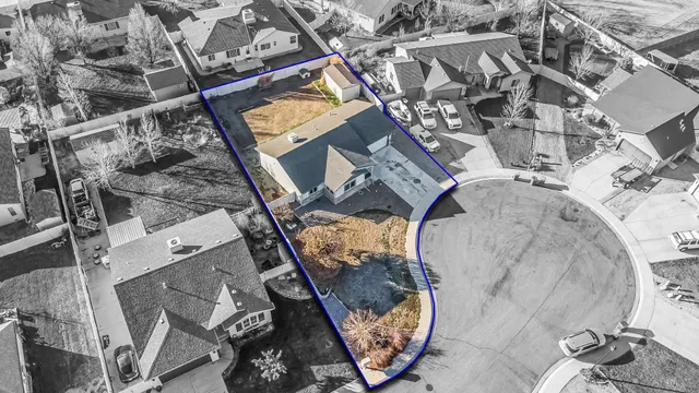 an aerial view of a backyard with table and chairs