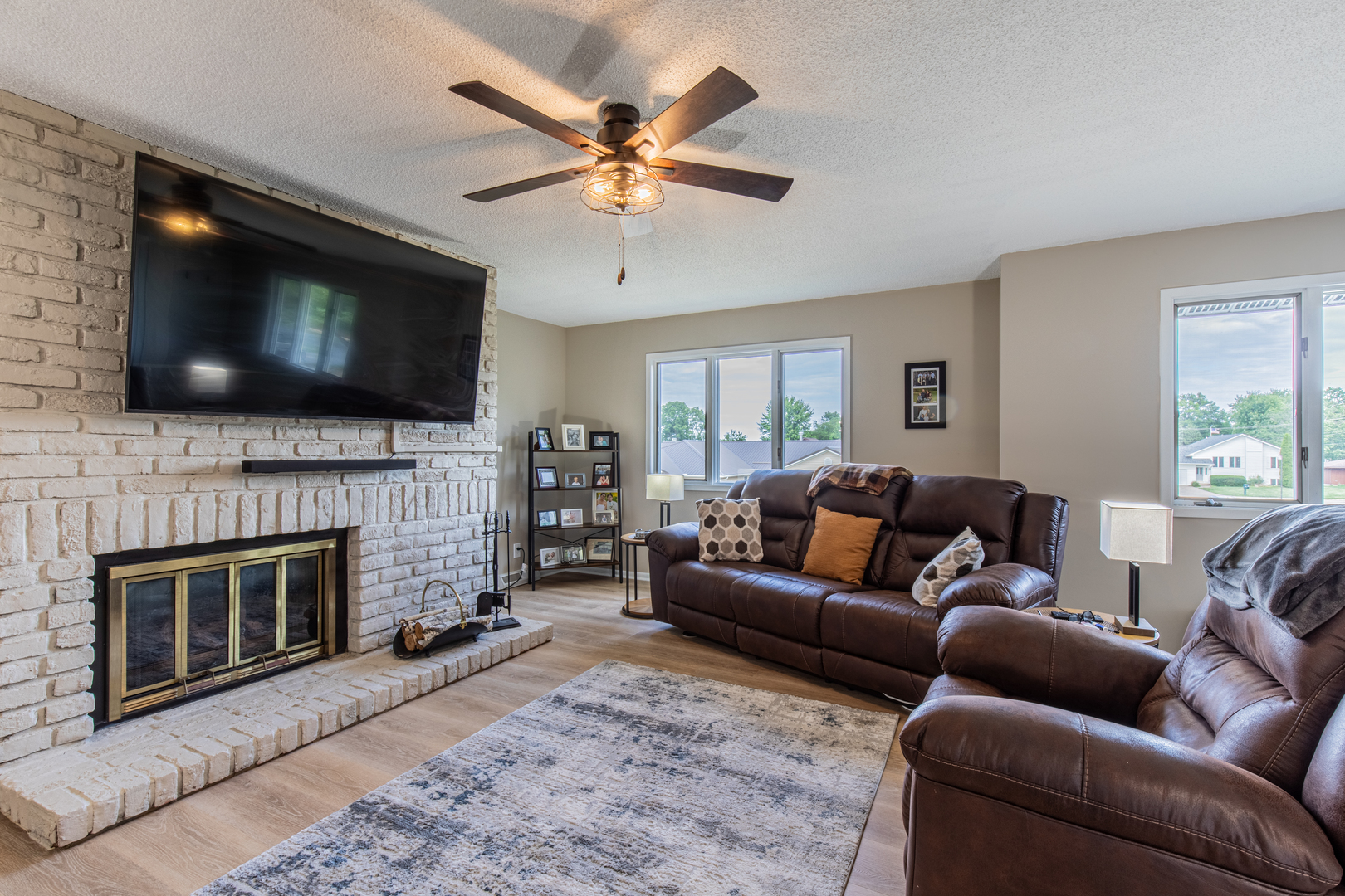 973 Innsbruck Lane, Unit 4G Princeton, IL 61356 - Photo 3 of 15 a living room with furniture a flat screen tv and a fireplace