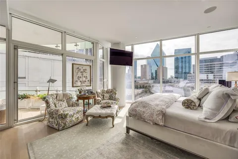 a living room with furniture and large windows