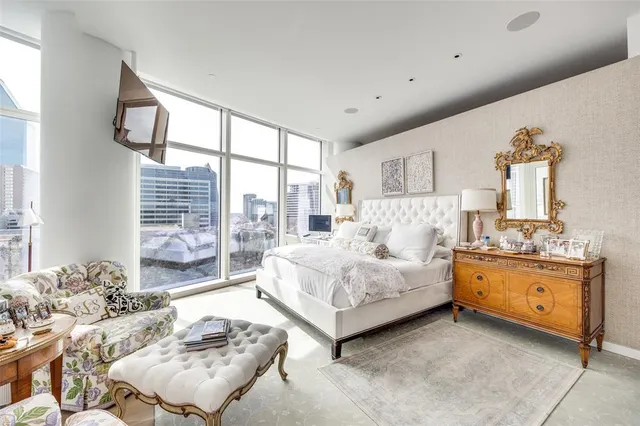 a spacious bedroom with a bed and window