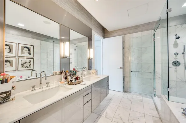 a bathroom with a double vanity sink mirror and shower