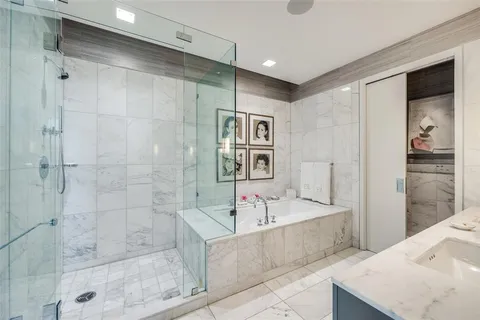a bathroom with a tub a sink and shower
