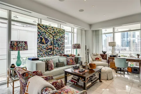 a living room with furniture large window and outdoor view