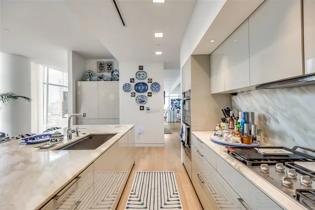 a kitchen with stainless steel appliances a stove a sink and a refrigerator