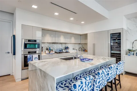 a kitchen with a table chairs refrigerator and cabinets