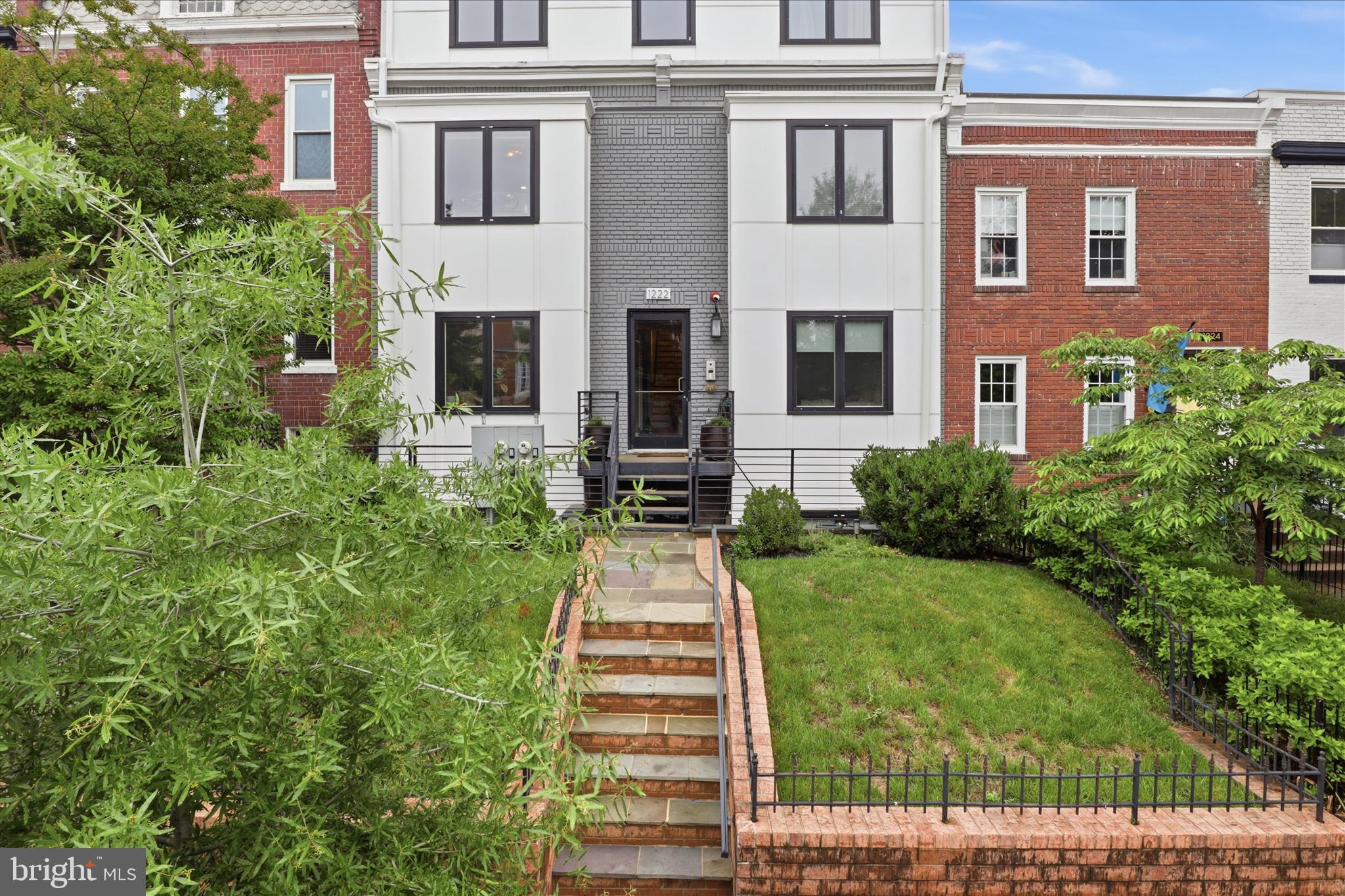 1222 Neal Street Northeast, Unit 3 Washington, DC 20002 - Photo 2 of 38 a front view of a house with a yard