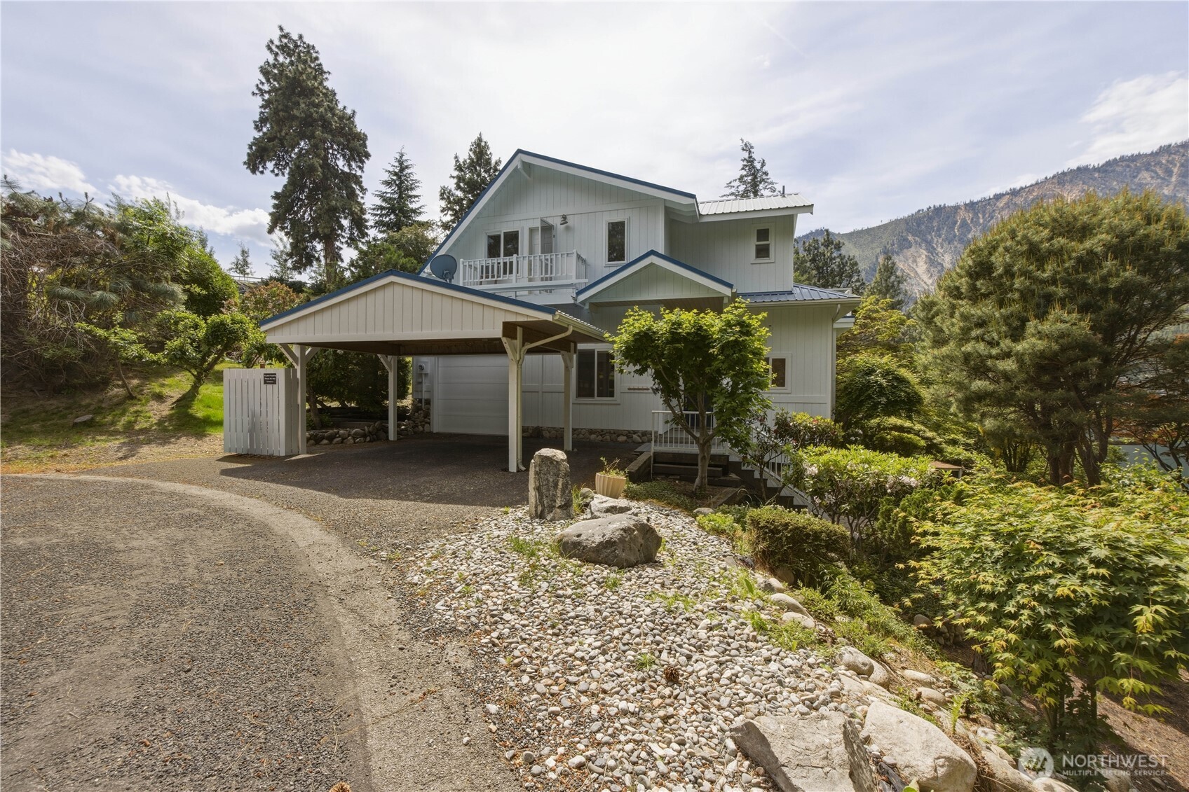 141 Sunset Place Manson, WA 98831 - Photo 4 of 38 a front view of a house with garden