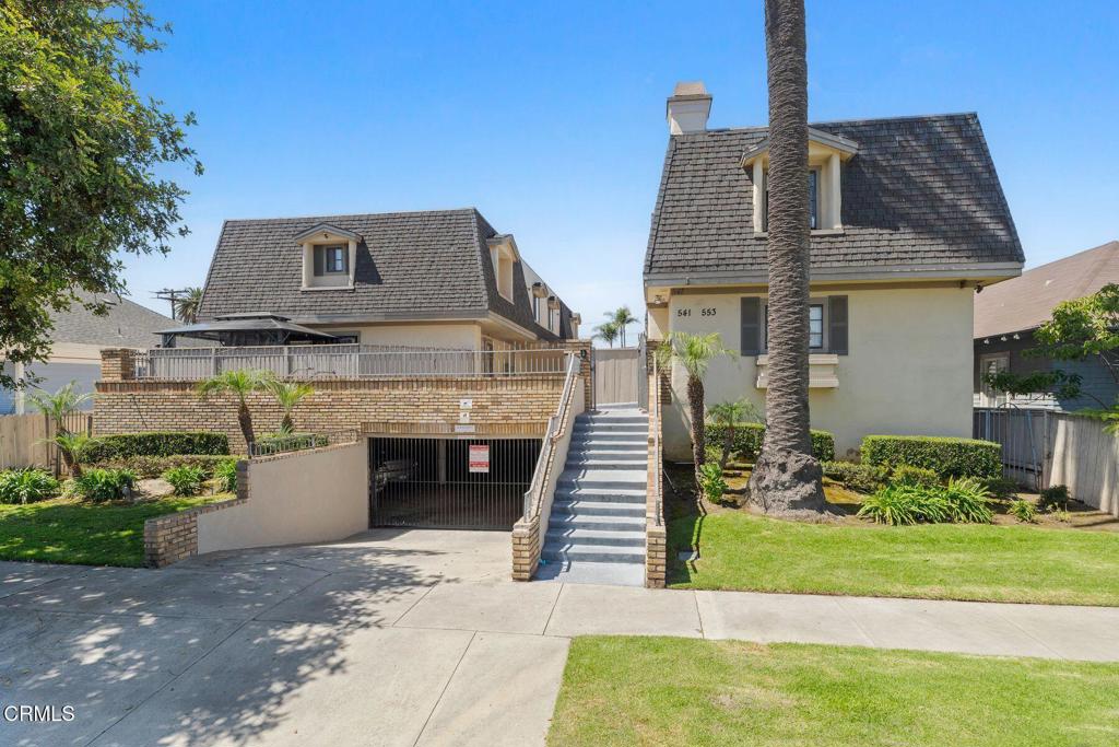 a front view of a house with a garden