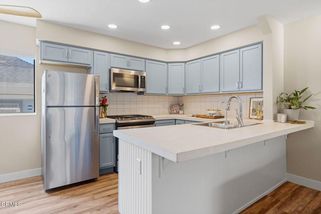 551 South E Street Oxnard, CA 93030 - Photo 6 of 16 a kitchen with stainless steel appliances a refrigerator sink and microwave