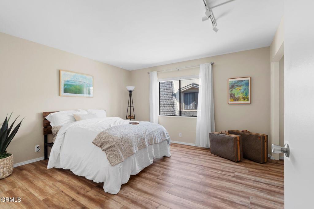 551 South E Street Oxnard, CA 93030 - Photo 9 of 16 a spacious bedroom with a bed and wooden floor