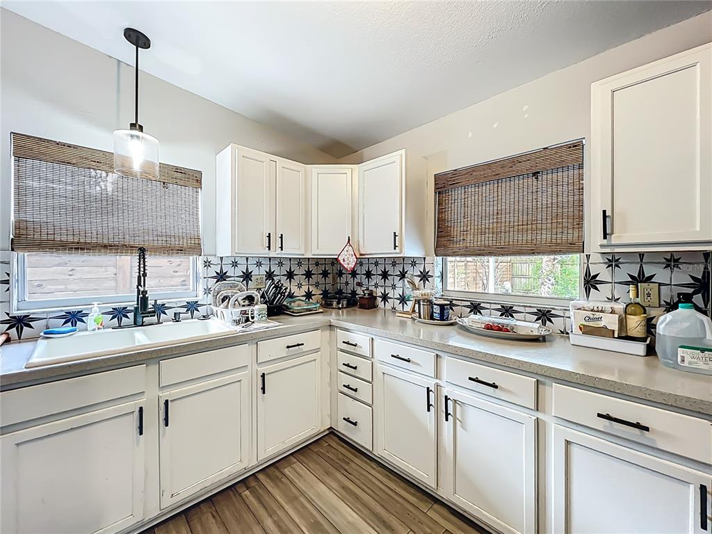 1700 Edmundshire Road Orlando, FL 32812 - Photo 15 of 43 a kitchen with a sink dishwasher window and cabinets