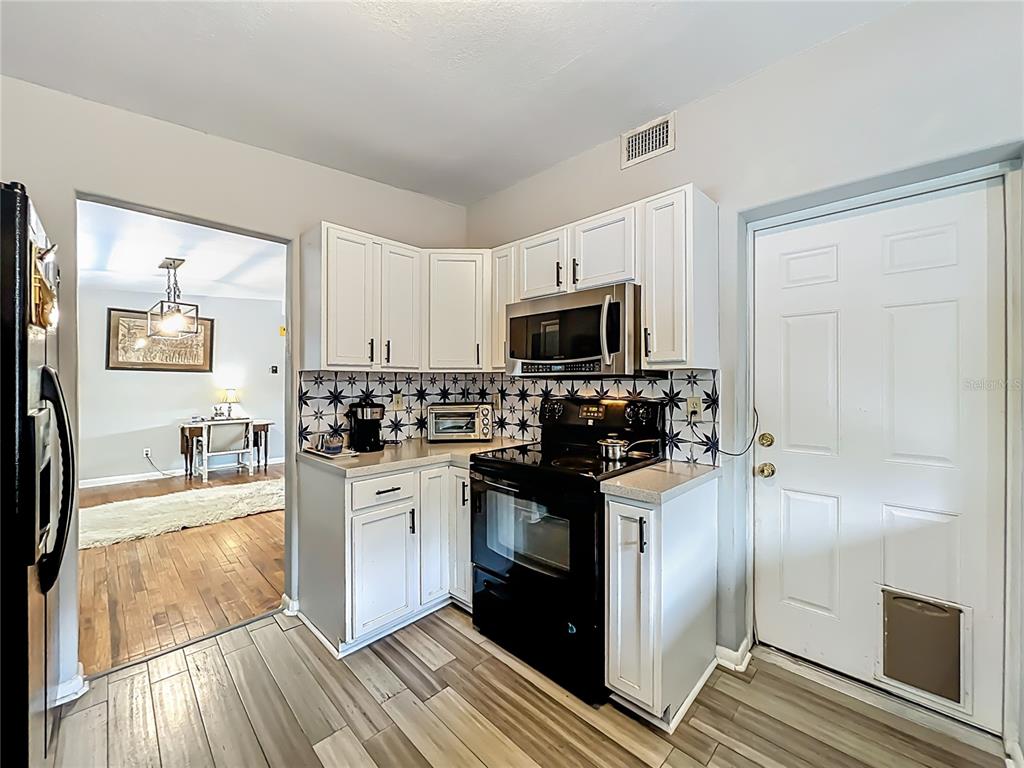 1700 Edmundshire Road Orlando, FL 32812 - Photo 16 of 43 a kitchen with a refrigerator stove and microwave
