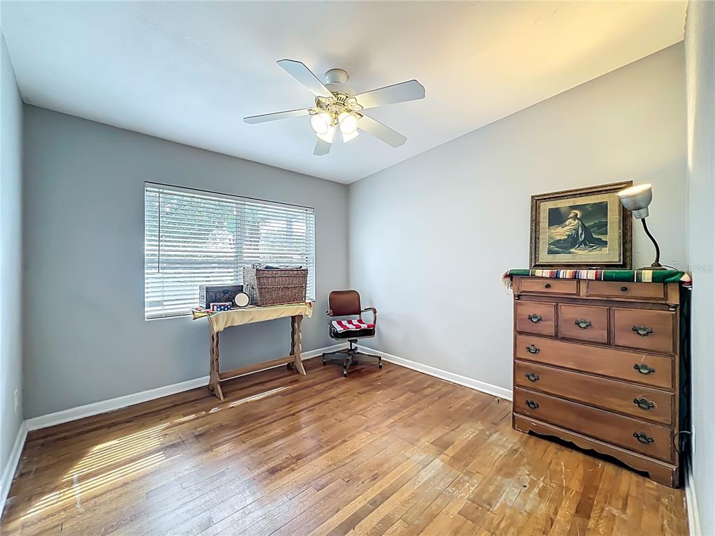 1700 Edmundshire Road Orlando, FL 32812 - Photo 18 of 43 a bedroom with a bed and a dresser