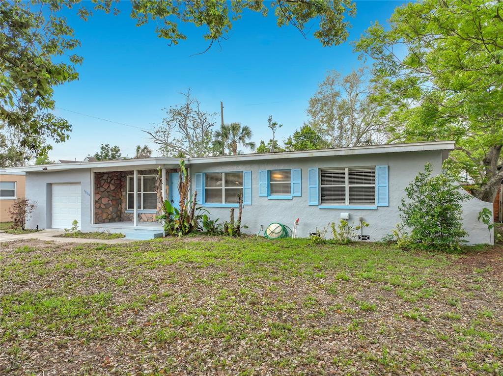 1700 Edmundshire Road Orlando, FL 32812 - Photo 2 of 43 front view of a house with a yard