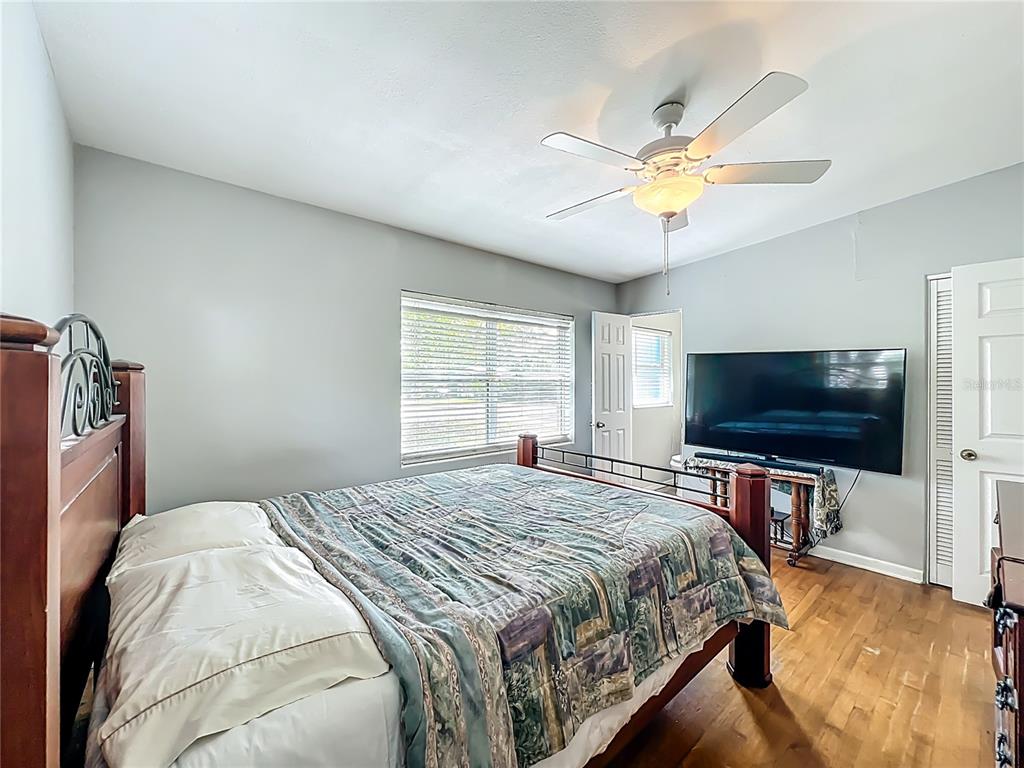 1700 Edmundshire Road Orlando, FL 32812 - Photo 26 of 43 a bedroom with a bed and a flat screen tv