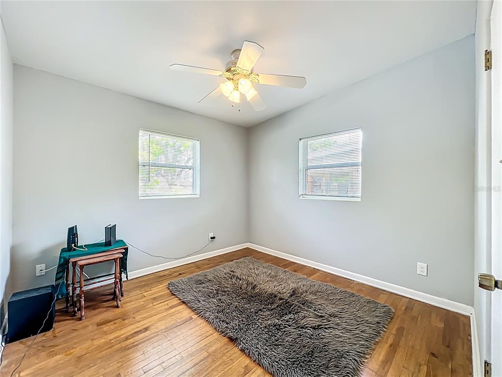 1700 Edmundshire Road Orlando, FL 32812 - Photo 28 of 43 a view of an empty room with window and wooden floor