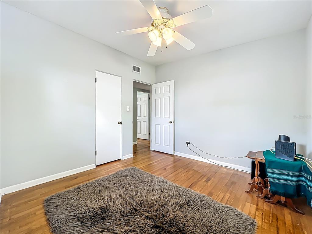 1700 Edmundshire Road Orlando, FL 32812 - Photo 29 of 43 a bedroom with a bed and a chandelier