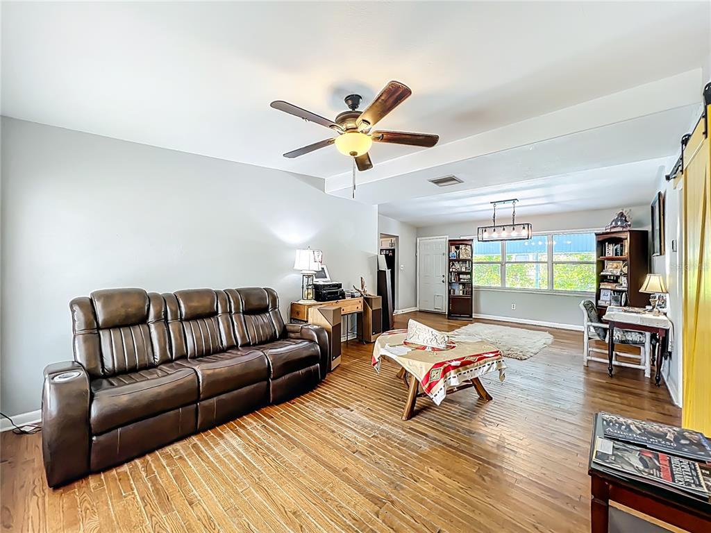 1700 Edmundshire Road Orlando, FL 32812 - Photo 6 of 43 a living room with furniture and wooden floor