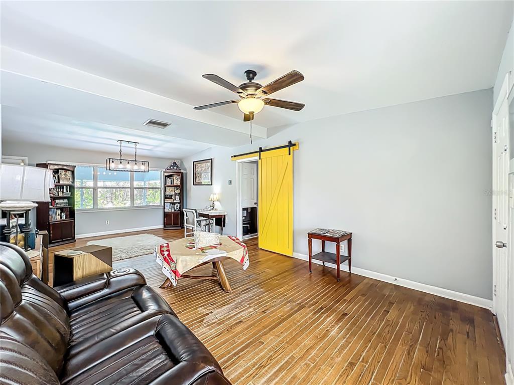 1700 Edmundshire Road Orlando, FL 32812 - Photo 7 of 43 a living room with furniture and a wooden floor